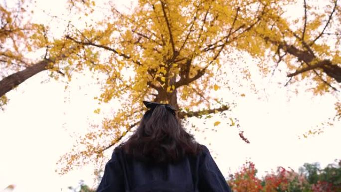 女子抛金秋叶头顶女子抛金秋叶头顶秋天