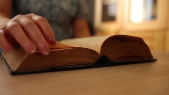 Reading a old book on table