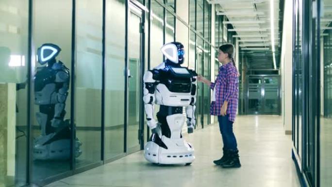 小女孩和一个未来派机器人说话。机器人科学、技术、创新概念。