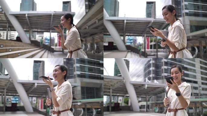 亚洲女商人在街上发送语音信息