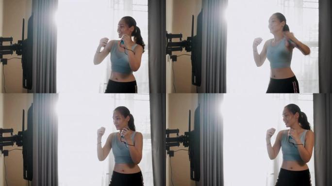 亚洲妇女在家锻炼打拳出拳视频素材