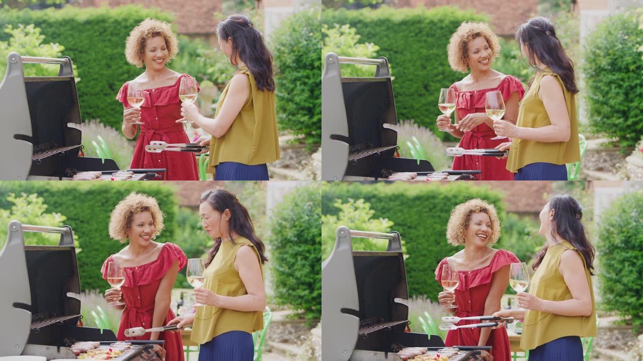 两个成熟的女性朋友在家做饭户外烧烤喝酒