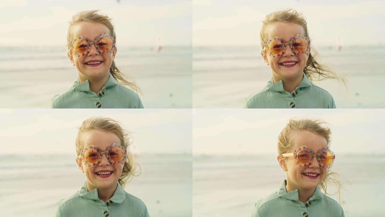 一个小女孩在海滩上戴着可爱的太阳镜的4k视频片段