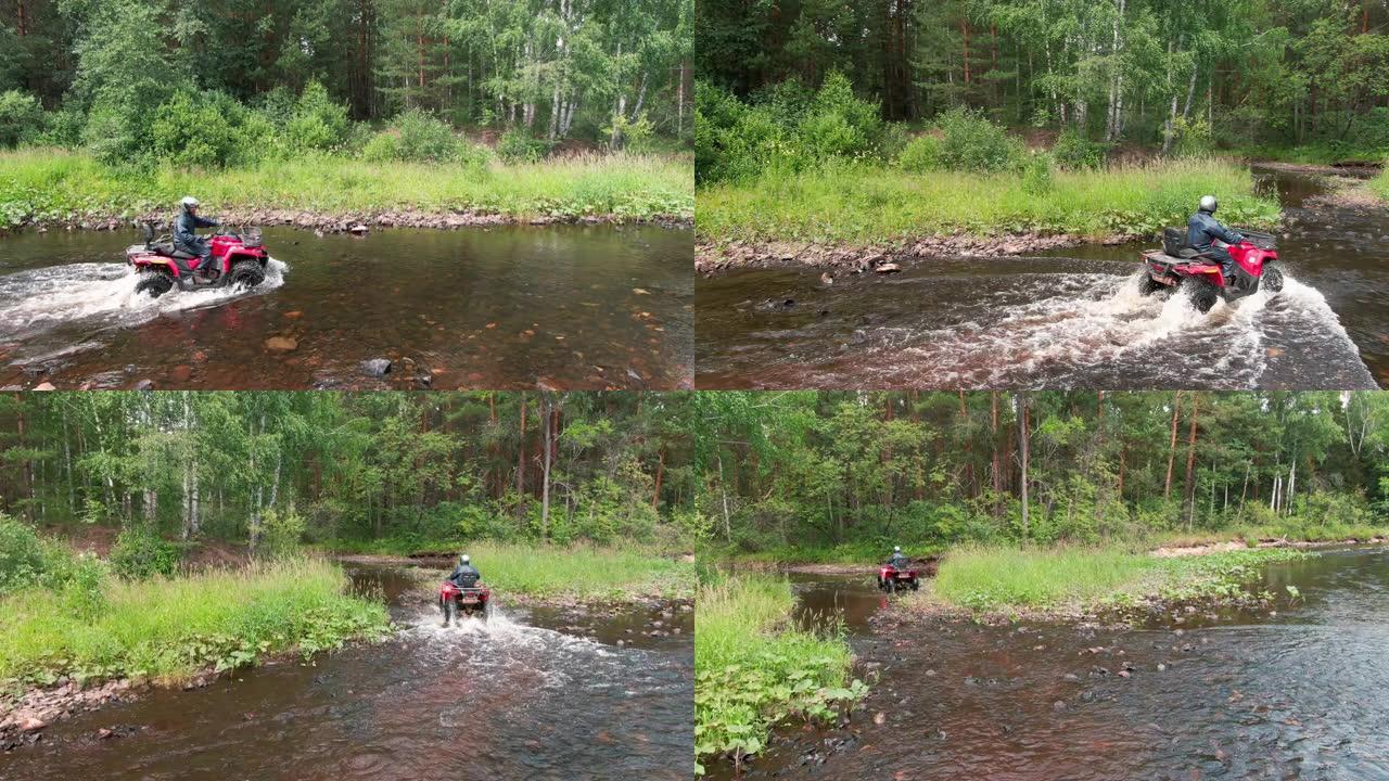 男子驾驶四轮摩托穿过河的无人机镜头