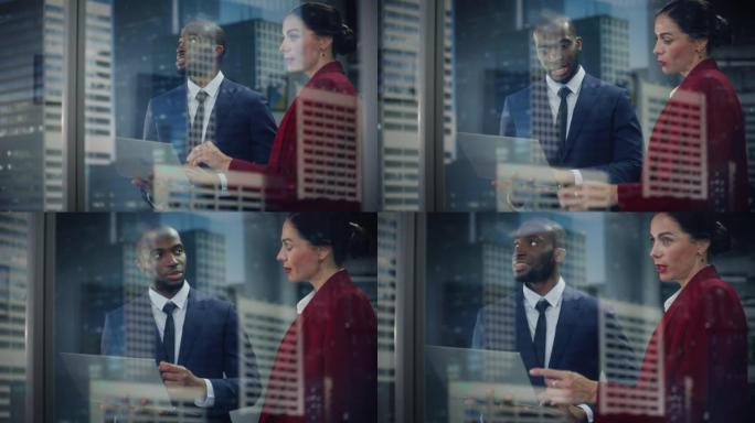 成功的公司首席执行官和投资经理的肖像，站在城市办公室时使用笔记本电脑交谈。两个成功的商人在电子商务软