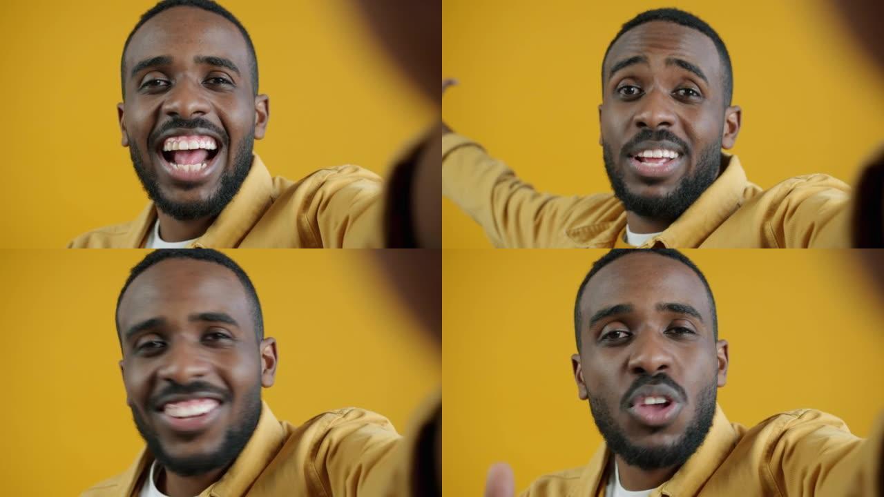 视频通话中英俊的非洲裔美国人看着相机说话的特写肖像