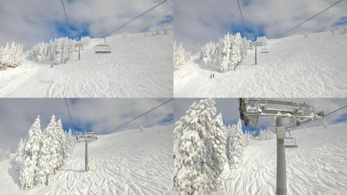 POV: 在斜坡上乘坐升降椅时，可以看到美丽的滑雪胜地的风景