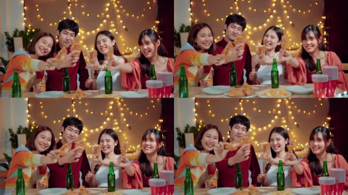 兴奋的女人和朋友在聚会上在餐桌上分享炸鸡。