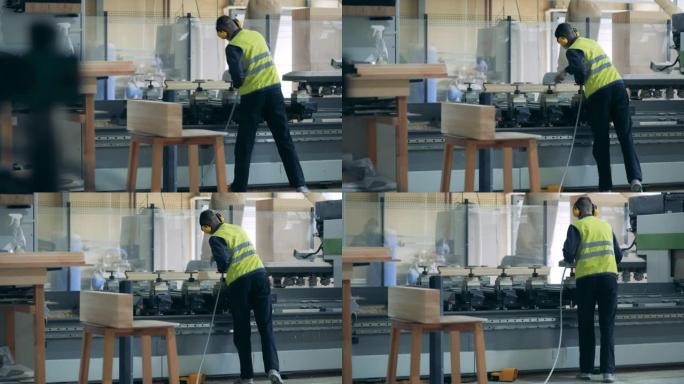 工厂工人正在工业机器上喷洒化学药品