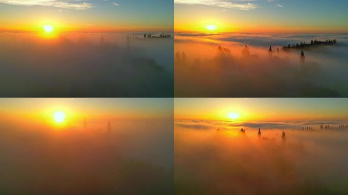日落时，空中教堂的塔楼从山顶的浓雾中伸出。杰鲁扎莱姆，吕托默。斯洛文尼亚的自治市。