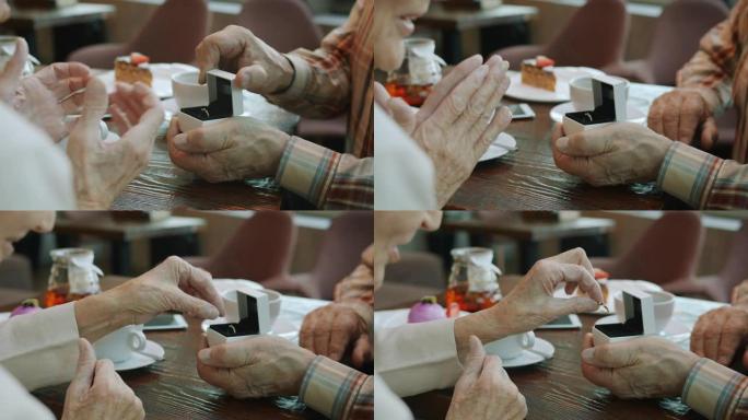老年男子双手打开首饰盒并给老年妇女戒指的慢动作特写