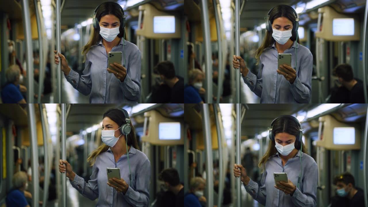 戴着医用口罩的年轻女子的肖像晚上乘地铁回家，用智能手机打字。女性乘坐公共交通工具旅行，尊重检疫规则，
