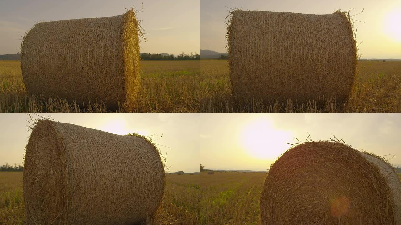 慢动作: 日落时分在田野上的干草捆