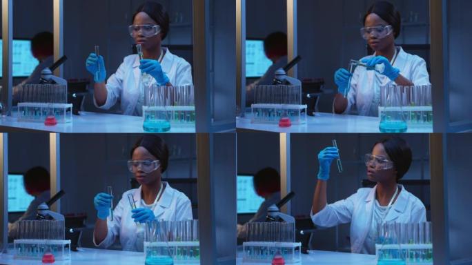一位年轻的非裔美国女实验室医生将绿色液体从一个试管倒入另一个试管的特写镜头