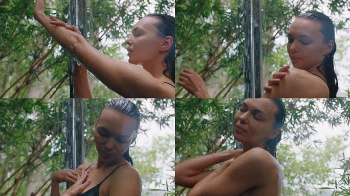 美丽的女人在淋浴穿着比基尼洗身体清洁皮肤与清爽的水享受自然美容温泉在大自然的户外淋浴