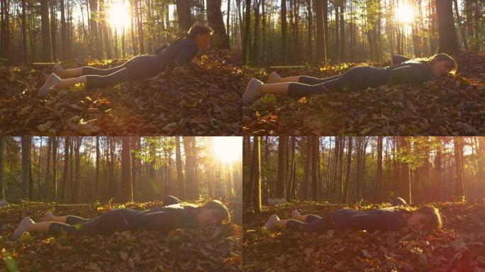 低角度: 慢跑者在阳光明媚的早晨在森林中奔跑时跌跌撞撞地