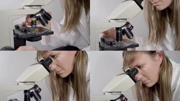 女性化学家在显微镜上切换镜头