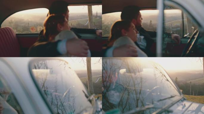 已婚夫妇坐在车内，欣赏日落时的景色