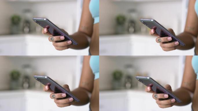 一个无法识别的女人在家锻炼后使用智能手机的4k视频片段