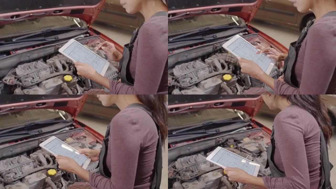 女机械师用平板电脑检查汽车