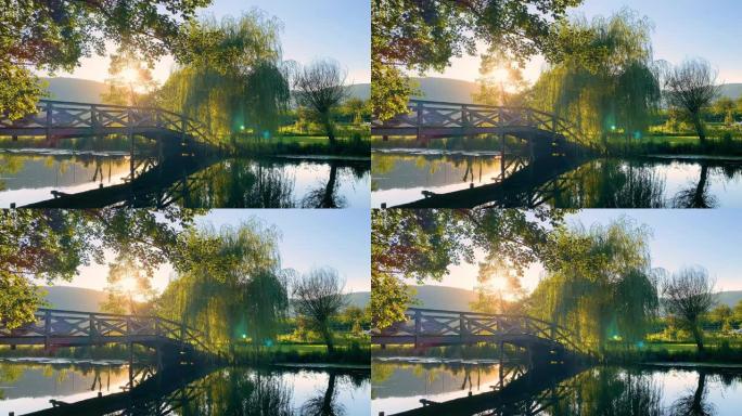 日落时分在河上的木桥上郁郁葱葱的树叶风景