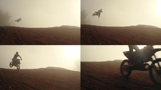 摩托车，轮廓和跳跃与沙漠天空的自行车景观。快速自行车运输和空中特技的免费室外路径。在大自然的山上有灰