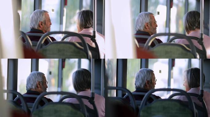 老年夫妇在公共汽车里一起聊天
