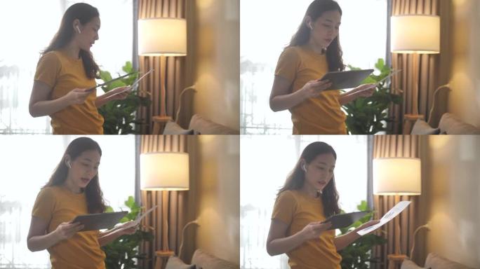 亚洲妇女在家里的客厅举行视频通话会议