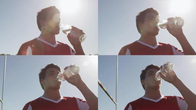 橄榄球运动员在晴天喝水