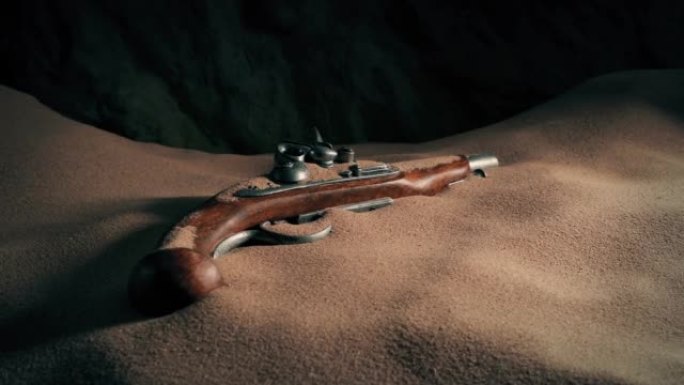 被沙子覆盖的洞穴中的燧发枪