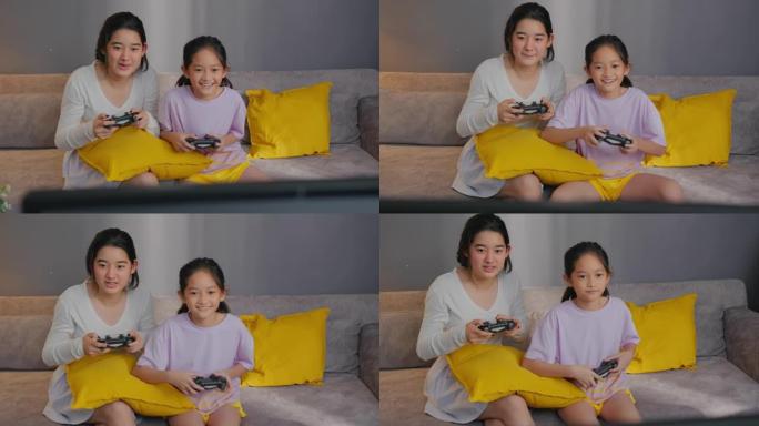 两个亚洲兄弟姐妹在家里的客厅玩电子游戏机