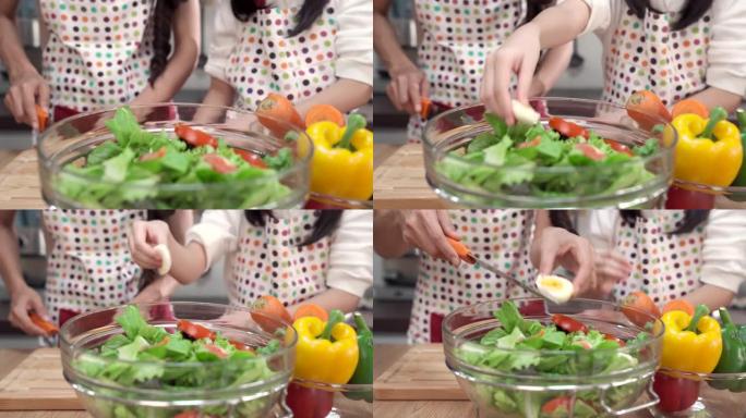 4K UHD多莉镜头放大特写: 快乐的亚洲多代家庭烹饪和一起准备沙拉。