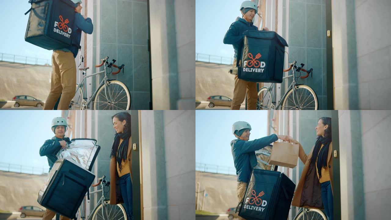 快乐的送餐男子在自行车上穿着保暖背包，向女性顾客提供餐厅订单。Courier在现代城市地区办公楼为华