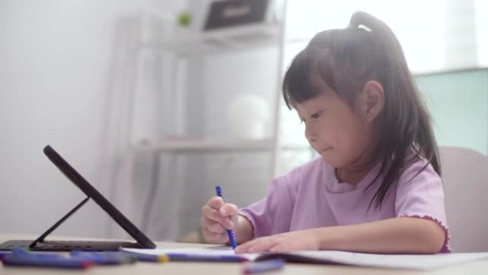 女孩在家中使用数字平板电脑进行电子学习课程