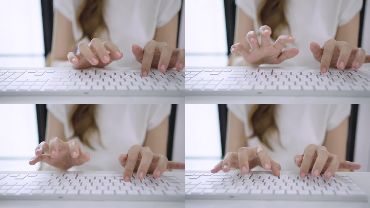 女人手在笔记本电脑键盘上打字的特写