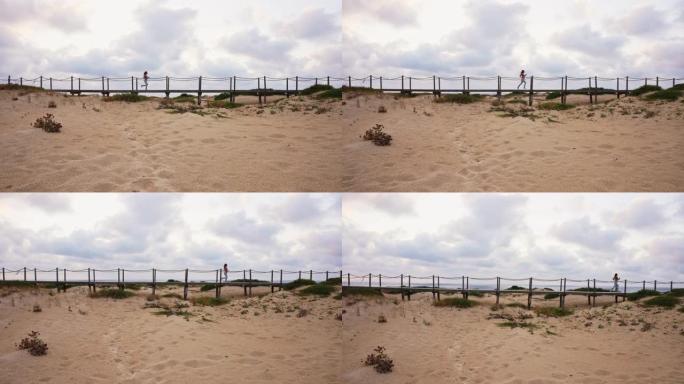在海滩上的木板路上奔跑的无法识别的女运动员的广角倾斜镜头