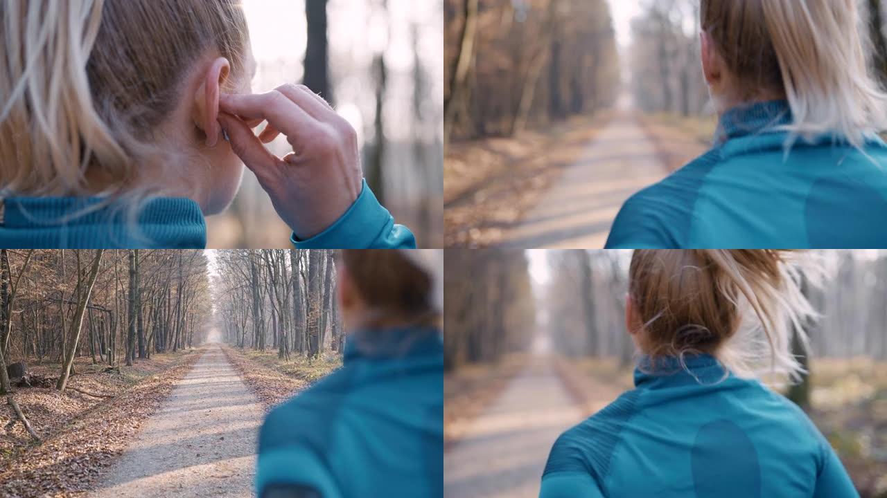 SLO MO女人在开始在森林里慢跑之前，将入耳式耳机放在耳朵里