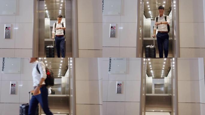 电梯，旅行和在机场与一名亚洲商人一起观看，检查他的航班起飞时间。门、地板和迟到，一名男性员工在旅行时