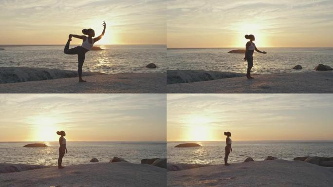 4k视频片段，一名年轻女子在海滩上摆瑜伽姿势