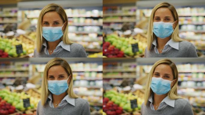 戴着医用口罩以保护自己免受疾病侵害的年轻女子的真实照片在超市里买杂货时，用购物车带着精选的食品在相机