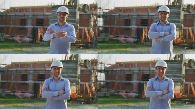 一位年轻的工程师在镜头前微笑着，对他在建筑工地背景下的工作感到满意。概念: 服务、建筑、事业人、建筑