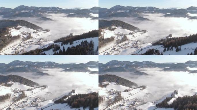 空中: 在朦胧的冬日早晨，宁静的朱利安阿尔卑斯山的小村庄。