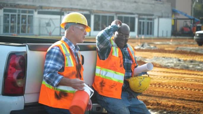 两名多种族建筑工人在喝咖啡休息