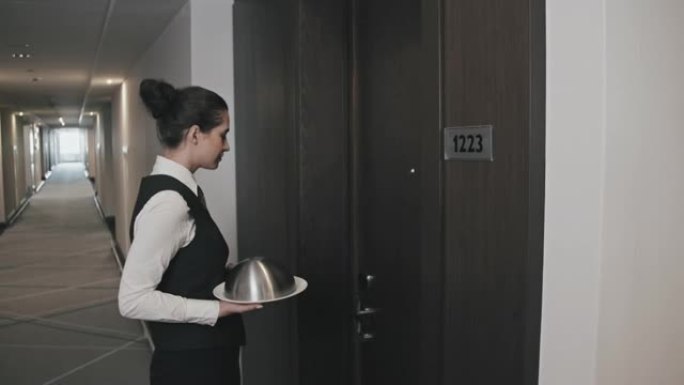 酒店的女服务员为房间提供食物