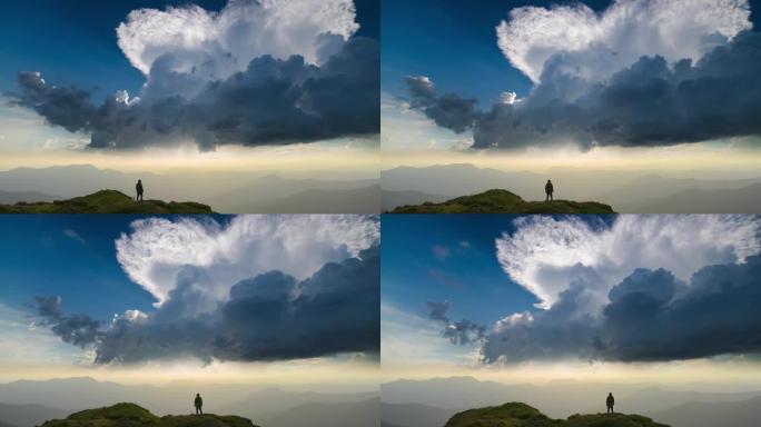 男性站在一座有着美丽云流背景的山上