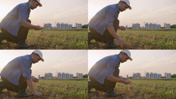 SLO MO Farmer检查田野中间的土壤