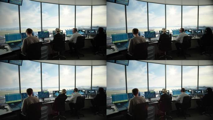 多元化的空中交通管制团队在现代化的机场塔中工作。办公室里满是台式电脑显示屏，配有导航屏幕，飞机飞行雷