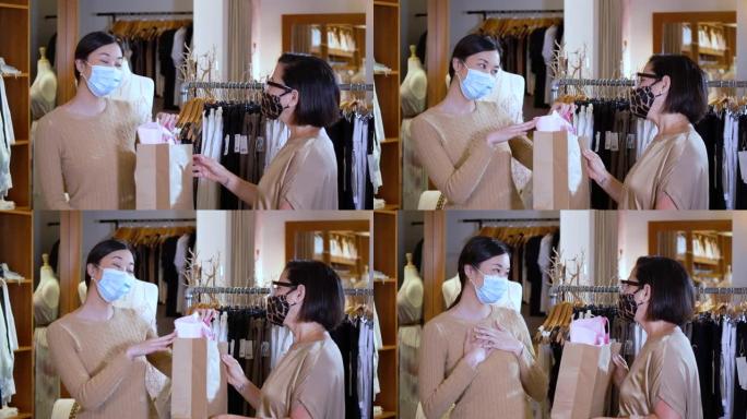 亚洲女售货员给顾客一个口罩购物袋