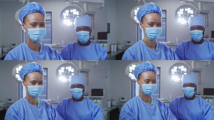 站在手术室中戴着口罩的男女外科医生的肖像