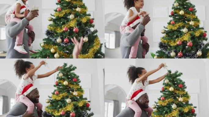 快乐的非洲裔美国父亲和女儿装饰圣诞树